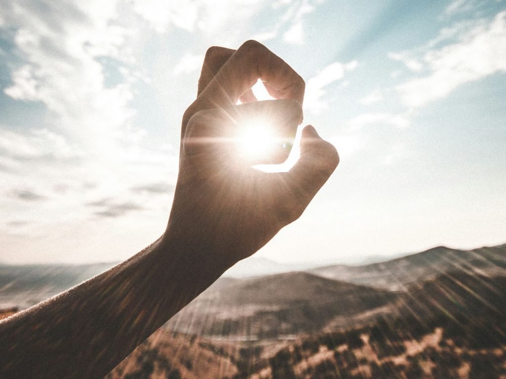Person catching the sun as researchers have shown how remote-controlled robots could build enormous structures like solar power arrays in space instead of risking astronauts.