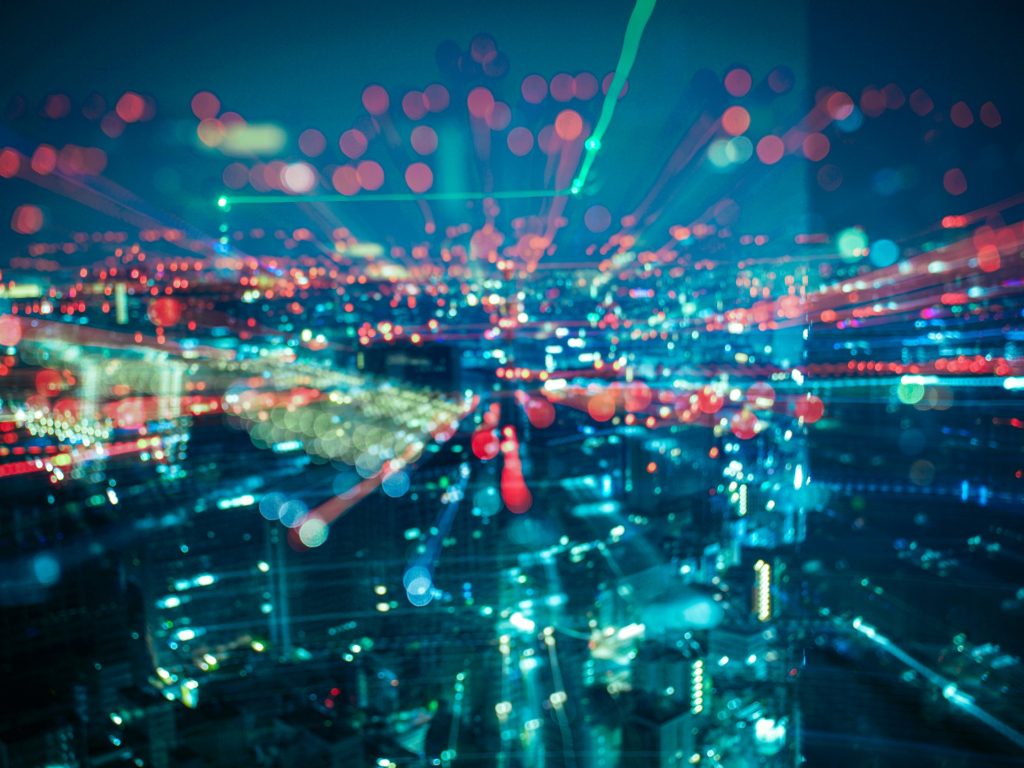 Digital lights illustration in a city as CSL Group is buying IoTM Solutions to consolidate multi-carrier SIM and eSIM management for enterprise IoT estates.