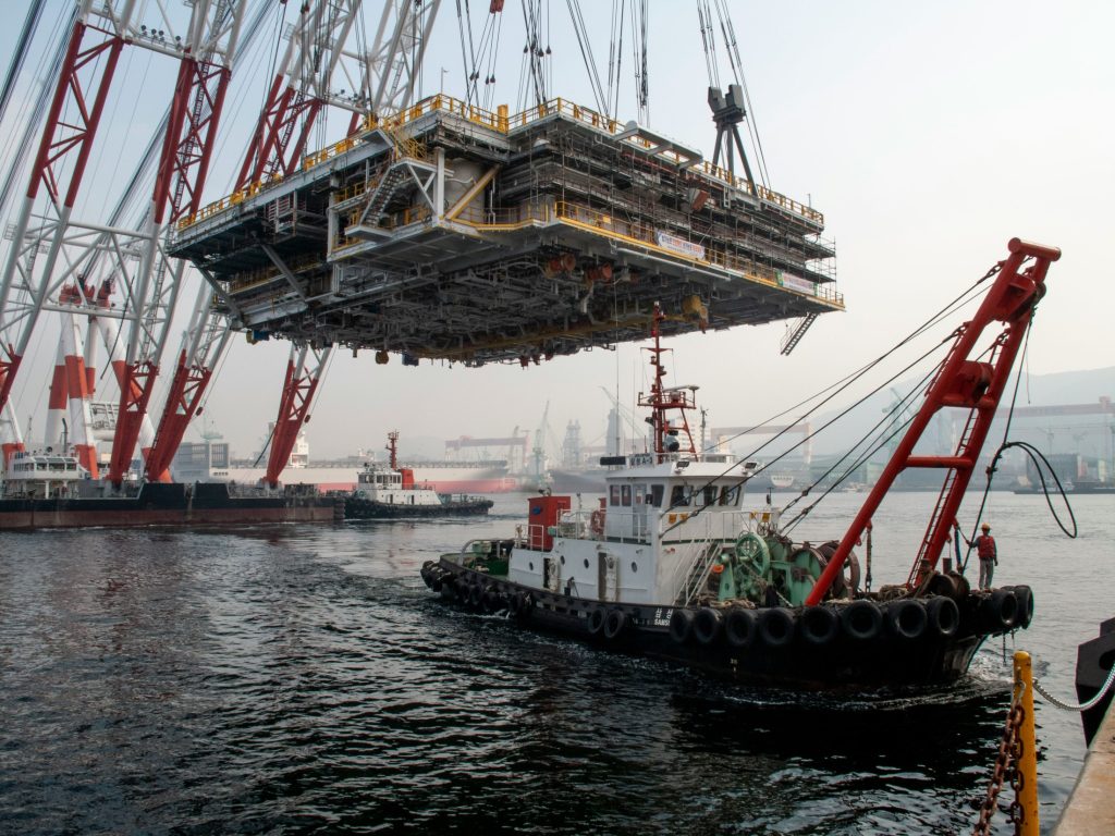 Large crane and boat as South Korea will allocate ₩1.4 trillion ($1.04 billion) across three regional AI manufacturing centres over the next five years under the expanded Shipbuilding M.AX Alliance.
